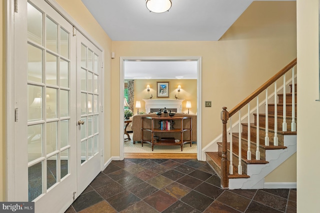 9020 Old Dominion Dr, Mclean, VA 22102 - foyer entrance featuring baseboards, stone tile flooring, a fireplace, and stairs