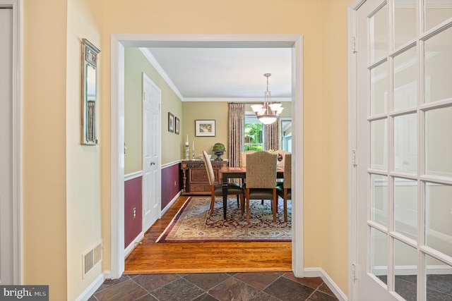 9020 Old Dominion Dr, Mclean, VA 22102 - dining area with crown molding, a chandelier, dark stone finish flooring, and baseboards