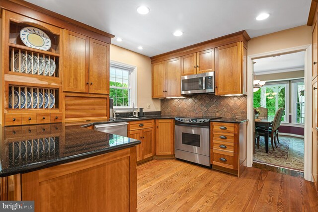 9020 Old Dominion Dr, Mclean, VA 22102 - kitchen featuring stainless steel appliances, light wood finished floors, tasteful backsplash, brown cabinetry, and open shelves