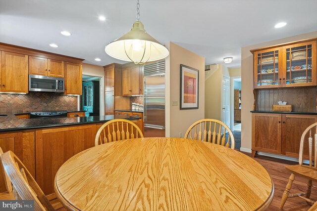 9020 Old Dominion Dr, Mclean, VA 22102 - kitchen with stainless steel appliances, wood finished floors, tasteful backsplash, glass insert cabinets, and recessed lighting