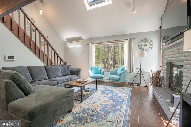 7572 Eagle Rock Dr, Tobyhanna, PA 18466 - living room with lofted ceiling, stairway, hardwood / wood-style flooring, a glass covered fireplace, and a textured ceiling