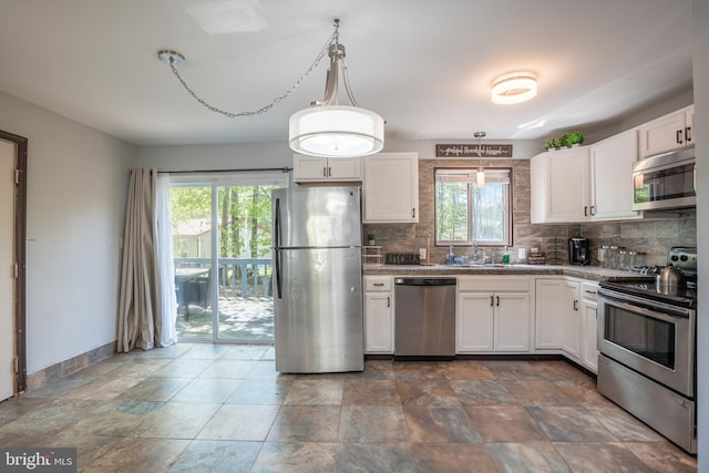 7572 Eagle Rock Dr, Tobyhanna, PA 18466 - kitchen with appliances with stainless steel finishes, decorative backsplash, and healthy amount of natural light