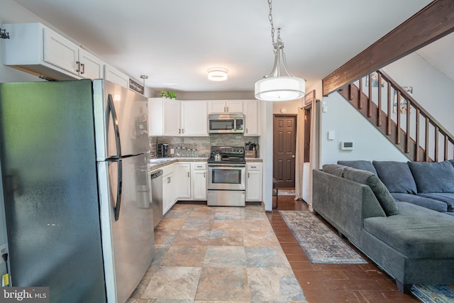 7572 Eagle Rock Dr, Tobyhanna, PA 18466 - kitchen featuring stainless steel appliances, open floor plan, tasteful backsplash, white cabinetry, and light countertops