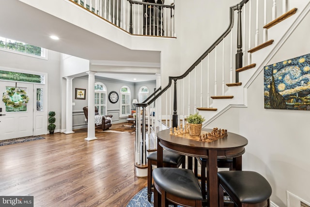 13128 Kahns Rd, Manassas, VA 20112 - entryway with a towering ceiling, ornate columns, wood finished floors, stairway, and recessed lighting