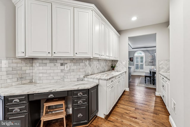 13128 Kahns Rd, Manassas, VA 20112 - kitchen with white cabinetry, recessed lighting, wood finished floors, backsplash, and light stone countertops