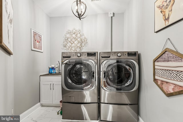 13128 Kahns Rd, Manassas, VA 20112 - washroom with baseboards, light marble finish floors, washing machine and clothes dryer, and cabinet space