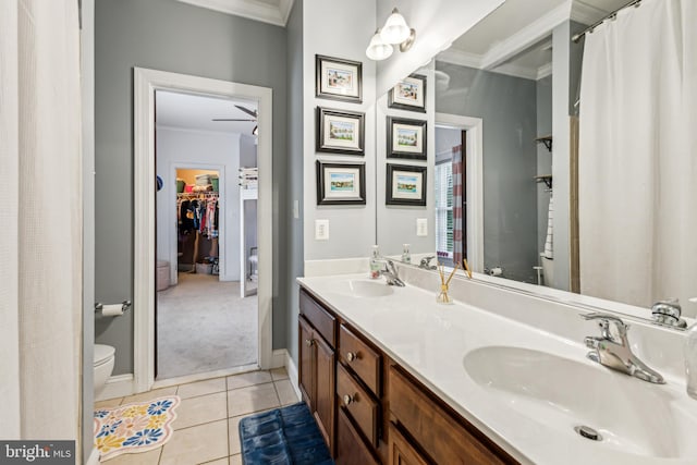 13128 Kahns Rd, Manassas, VA 20112 - bathroom featuring crown molding, toilet, tile patterned flooring, double vanity, and baseboards