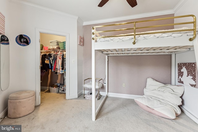 13128 Kahns Rd, Manassas, VA 20112 - carpeted bedroom featuring a walk in closet, a closet, ornamental molding, baseboards, and a ceiling fan