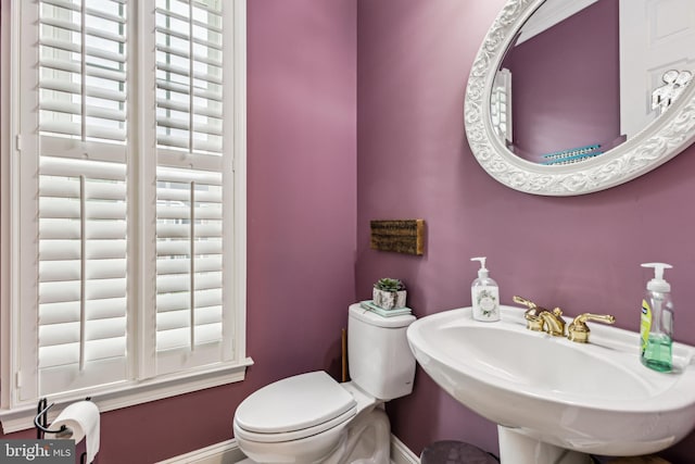 13128 Kahns Rd, Manassas, VA 20112 - bathroom featuring toilet, baseboards, and a sink