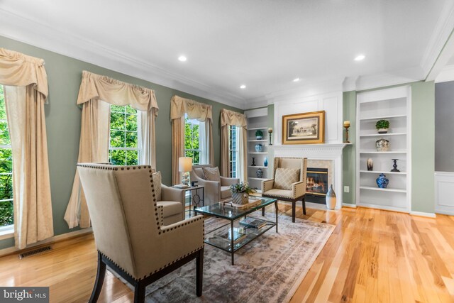 6249 Auburn Leaf Ln, Alexandria, VA 22312 - living area featuring ornamental molding, wood finished floors, a high end fireplace, recessed lighting, and built in shelves