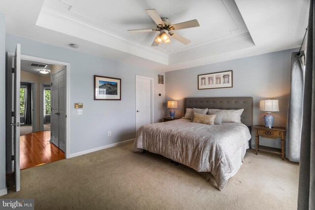 6249 Auburn Leaf Ln, Alexandria, VA 22312 - bedroom featuring a raised ceiling, light colored carpet, ornamental molding, baseboards, and a ceiling fan
