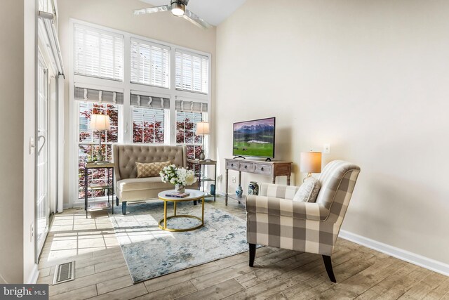 6249 Auburn Leaf Ln, Alexandria, VA 22312 - living area featuring high vaulted ceiling, wood finished floors, ceiling fan, and baseboards