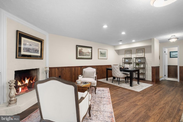 6358 Brampton Ct, Alexandria, VA 22304 - living area with wainscoting, dark wood-type flooring, a lit fireplace, recessed lighting, and a textured ceiling