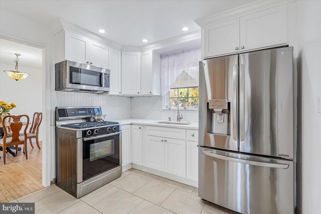 6009 Shady Spring Ave, Rosedale, MD 21237 - kitchen with appliances with stainless steel finishes, a sink, white cabinetry, backsplash, and light countertops