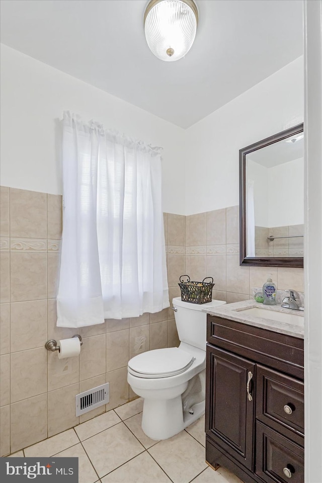 6009 Shady Spring Ave, Rosedale, MD 21237 - bathroom with tile walls, tile patterned flooring, toilet, and vanity