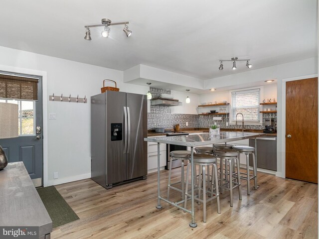 125 S Main St, Mahanoy City, PA 17948 - kitchen featuring stainless steel appliances, open shelves, light wood-style floors, and backsplash