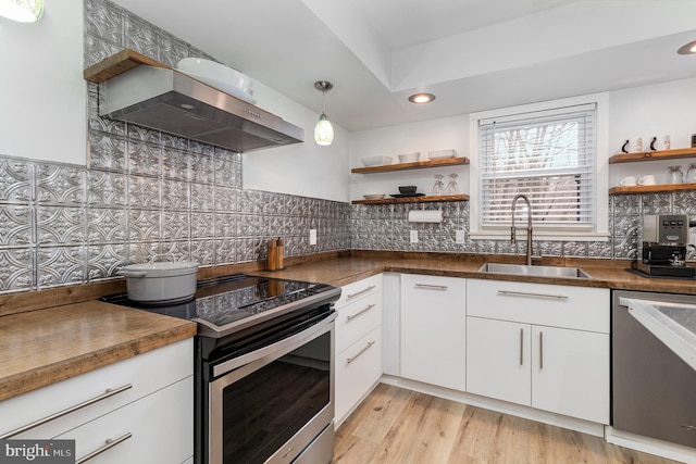 125 S Main St, Mahanoy City, PA 17948 - kitchen featuring appliances with stainless steel finishes, a sink, open shelves, wall chimney exhaust hood, and white cabinets