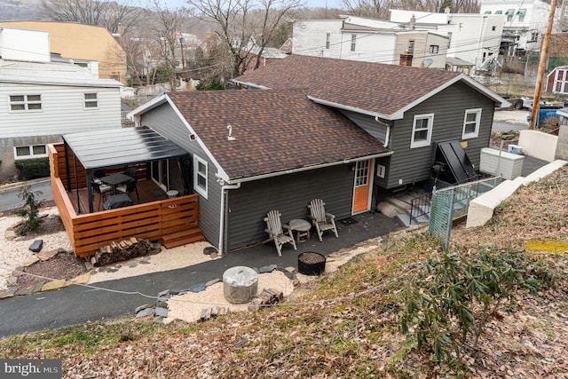 125 S Main St, Mahanoy City, PA 17948 - back of property featuring roof with shingles, an outdoor fire pit, and a wooden deck