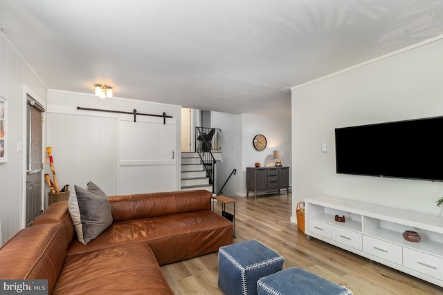 125 S Main St, Mahanoy City, PA 17948 - living area featuring a barn door, light wood-style floors, and stairs