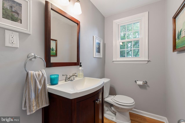 207 Wilshire Ln, Newark, DE 19711 - half bath featuring vanity, toilet, wood finished floors, and baseboards