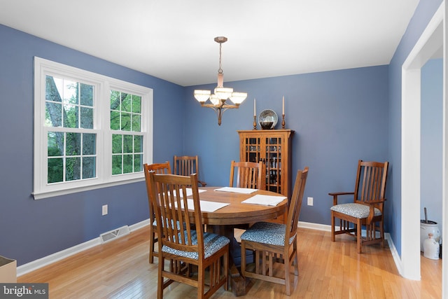 207 Wilshire Ln, Newark, DE 19711 - dining space featuring a chandelier, light wood-style flooring, and baseboards