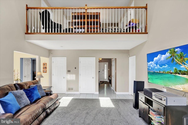 29 Colorado Ave, Sinking Spring, PA 19608 - carpeted living area featuring a towering ceiling, tile patterned floors, and baseboards
