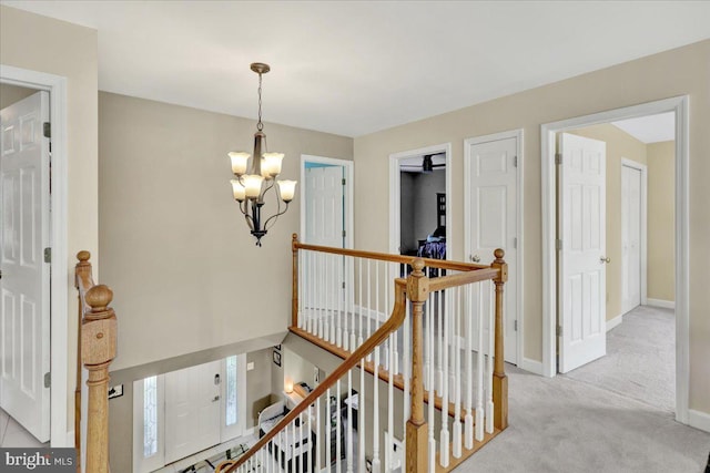 29 Colorado Ave, Sinking Spring, PA 19608 - hall featuring an upstairs landing, a chandelier, carpet flooring, and baseboards