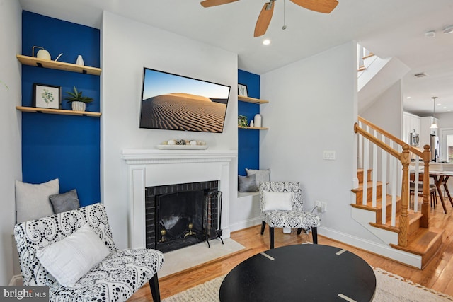 300 15th St SE, Washington, DC 20003 - living area featuring wood finished floors, stairs, a ceiling fan, a fireplace, and baseboards
