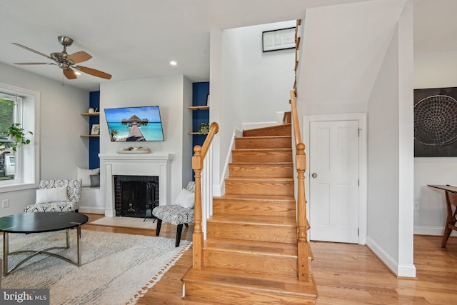 300 15th St SE, Washington, DC 20003 - staircase featuring a ceiling fan, a fireplace, wood finished floors, recessed lighting, and baseboards