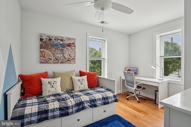 300 15th St SE, Washington, DC 20003 - bedroom with light wood finished floors, an office area, baseboards, and a ceiling fan