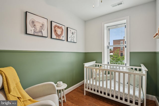 300 15th St SE, Washington, DC 20003 - bedroom with wood finished floors, baseboards, and a crib