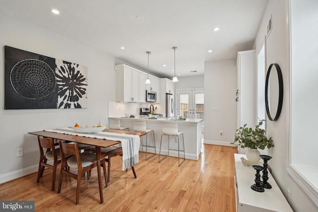 300 15th St SE, Washington, DC 20003 - dining room featuring recessed lighting, light wood finished floors, baseboards, and french doors
