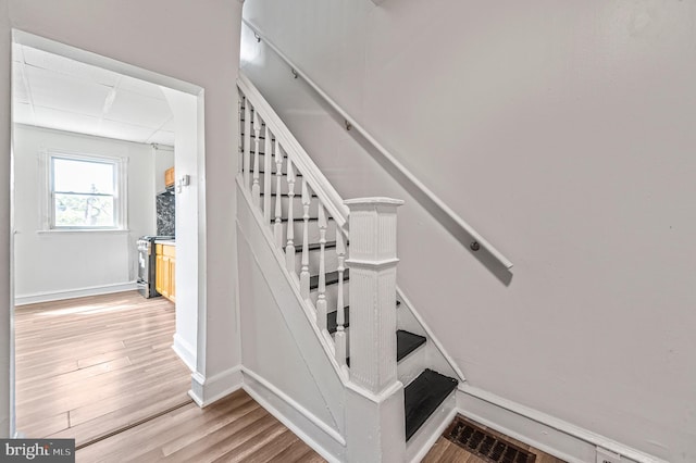2204 Yelland St, Philadelphia, PA 19140 - staircase featuring wood finished floors, baseboards, and a drop ceiling