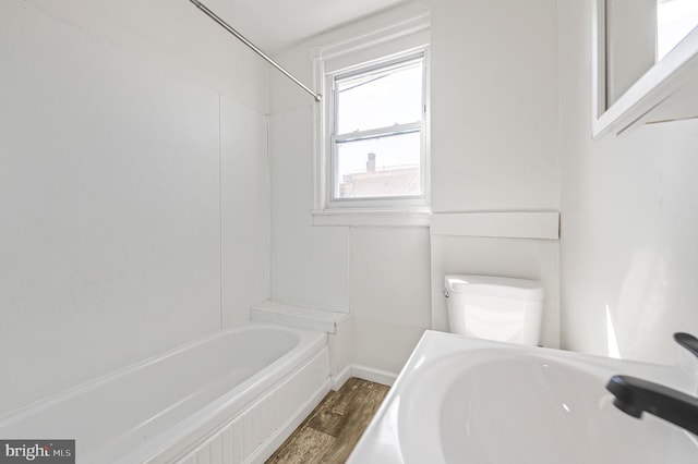 2204 Yelland St, Philadelphia, PA 19140 - bathroom featuring wood finished floors, toilet, baseboards, and shower / tub combination