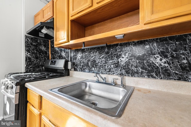 2204 Yelland St, Philadelphia, PA 19140 - kitchen featuring gas stove, a sink, extractor fan, light countertops, and decorative backsplash