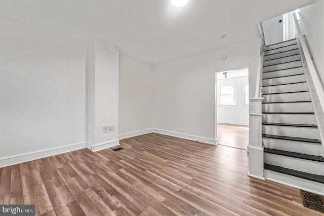2204 Yelland St, Philadelphia, PA 19140 - unfurnished living room with stairs, baseboards, and wood finished floors