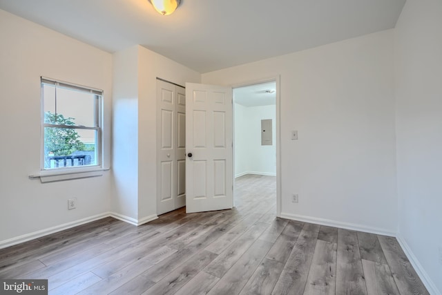 227 Elizabeth Ave, Baltimore, MD 21225 - unfurnished bedroom featuring wood finished floors, baseboards, and a closet