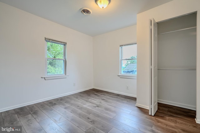 227 Elizabeth Ave, Baltimore, MD 21225 - unfurnished bedroom featuring hardwood / wood-style flooring, baseboards, and a closet