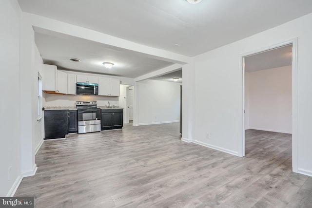 227 Elizabeth Ave, Baltimore, MD 21225 - kitchen with appliances with stainless steel finishes, light wood-type flooring, light countertops, and a sink