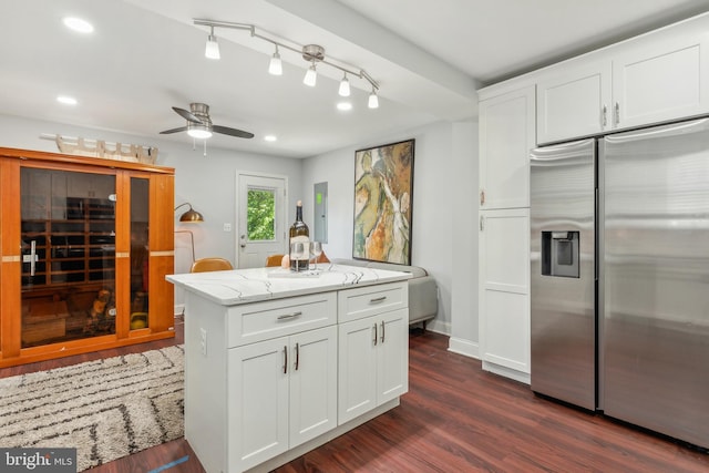 202 E Lafayette Ave, Baltimore, MD 21202 - kitchen with stainless steel fridge, light stone countertops, a ceiling fan, dark wood finished floors, and white cabinets