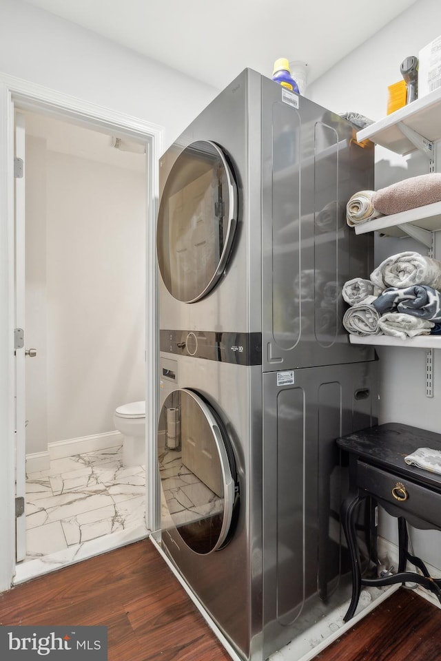 202 E Lafayette Ave, Baltimore, MD 21202 - laundry room featuring stacked washer / dryer, marble finish floors, and baseboards