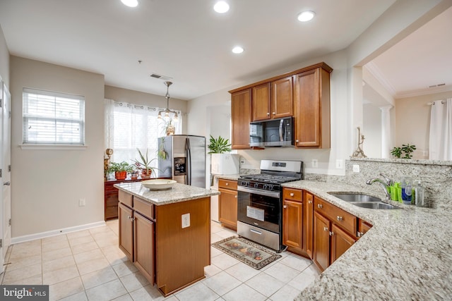 9722 Holmes Pl Unit 307, Manassas Park, VA 20111 - kitchen featuring stainless steel appliances, a sink, brown cabinets, light stone countertops, and recessed lighting