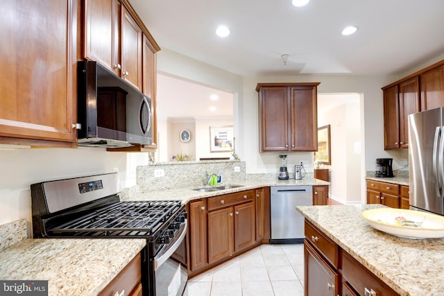 9722 Holmes Pl Unit 307, Manassas Park, VA 20111 - kitchen with appliances with stainless steel finishes, a sink, recessed lighting, light stone countertops, and light tile patterned floors