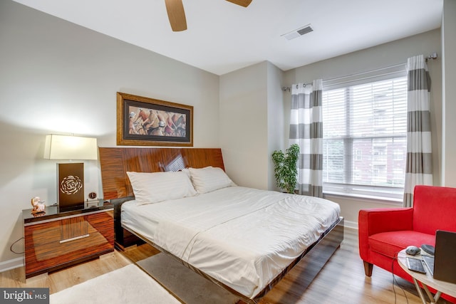 9722 Holmes Pl Unit 307, Manassas Park, VA 20111 - bedroom featuring wood finished floors, baseboards, multiple windows, and a ceiling fan