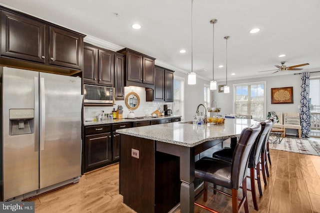 13304 Windy Meadow Ln, Silver Spring, MD 20906 - kitchen with appliances with stainless steel finishes, a sink, light stone countertops, recessed lighting, and light wood finished floors