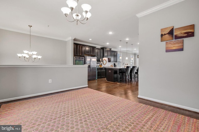 13304 Windy Meadow Ln, Silver Spring, MD 20906 - kitchen featuring a chandelier, stainless steel appliances, ornamental molding, a kitchen breakfast bar, and light countertops