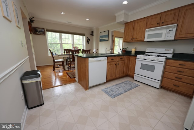 508 Limerick Cir Unit 402, Lutherville Timonium, MD 21093 - kitchen with white appliances, dark countertops, brown cabinetry, a peninsula, and ornamental molding