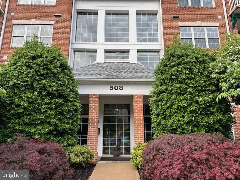 508 Limerick Cir Unit 402, Lutherville Timonium, MD 21093 - property entrance featuring brick siding and roof with shingles