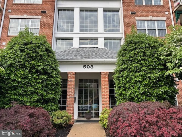 508 Limerick Cir Unit 402, Lutherville Timonium, MD 21093 - property entrance featuring brick siding and roof with shingles