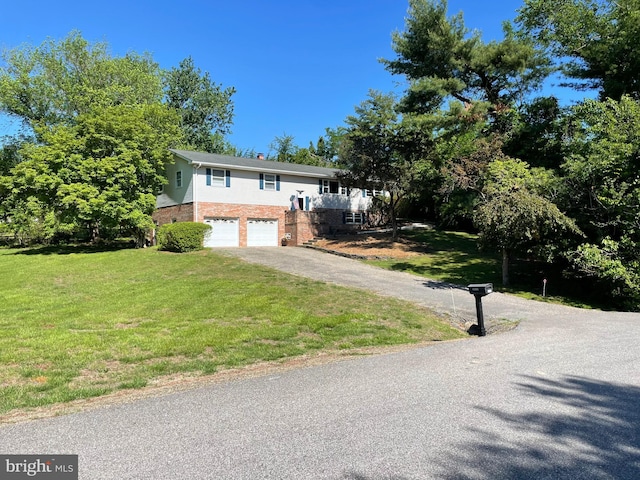 23359 Patuxent View Rd, Lexington Park, MD 20653 - raised ranch with driveway, a garage, brick siding, and a front yard